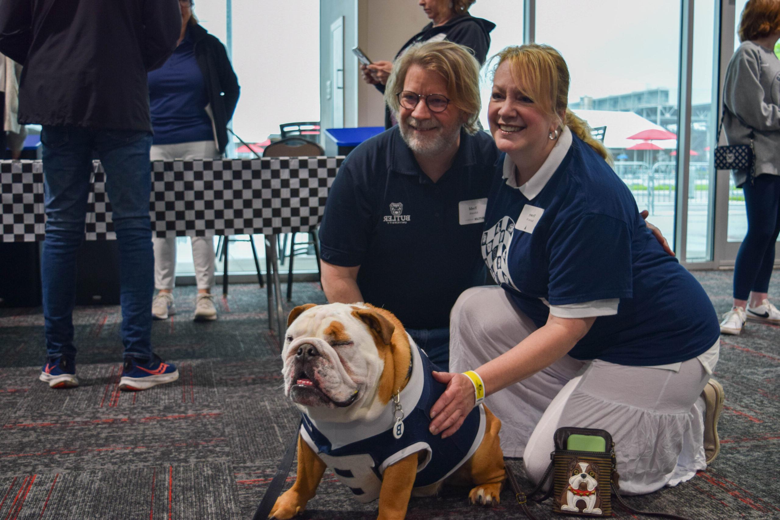 Alumni pose with Butler Blue IV at the annual Bulldogs at the Brickyard event